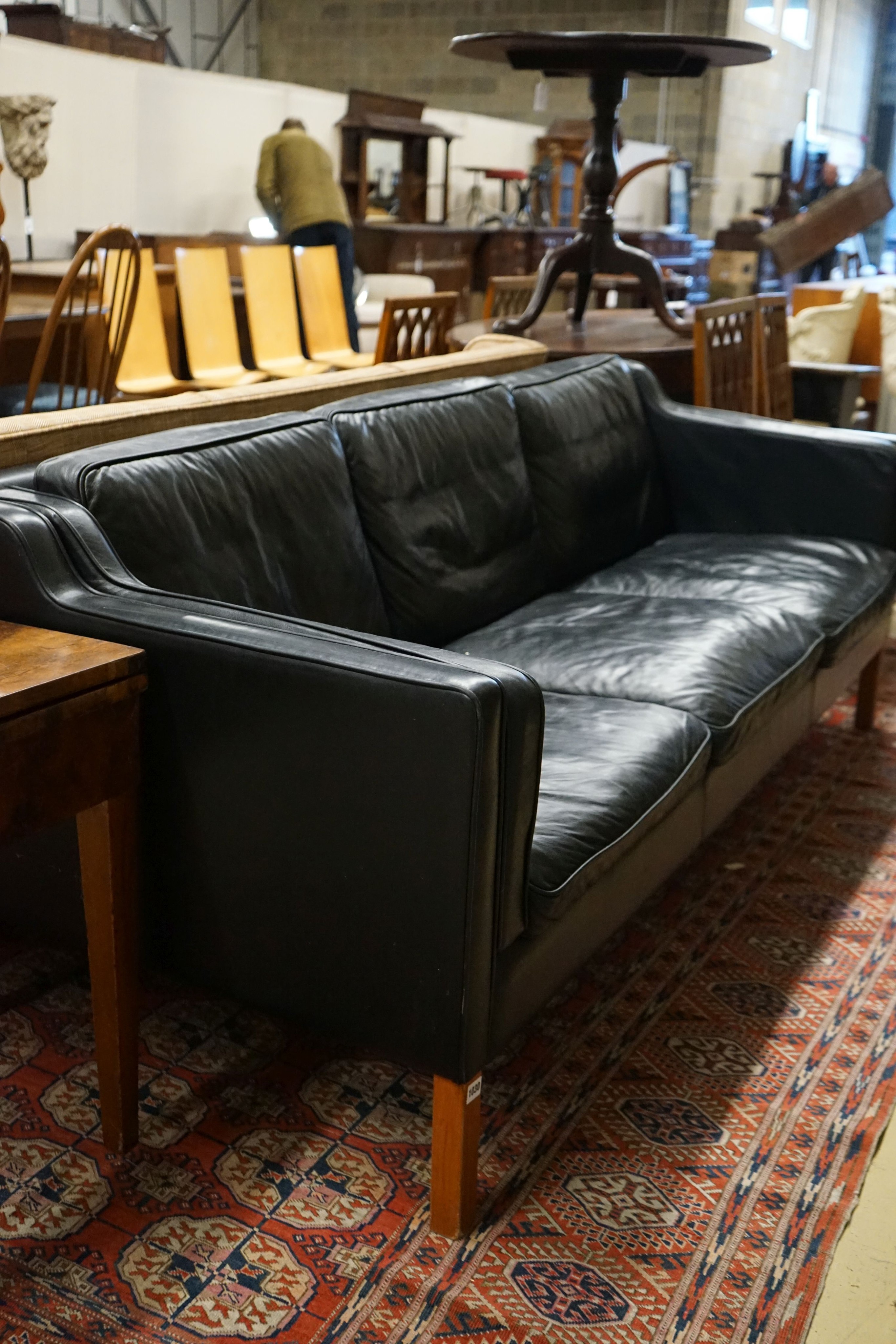 A mid century Danish black leather three seater sofa in the style of Borge Mogensen, length 201cm, depth 80cm, height 76cm